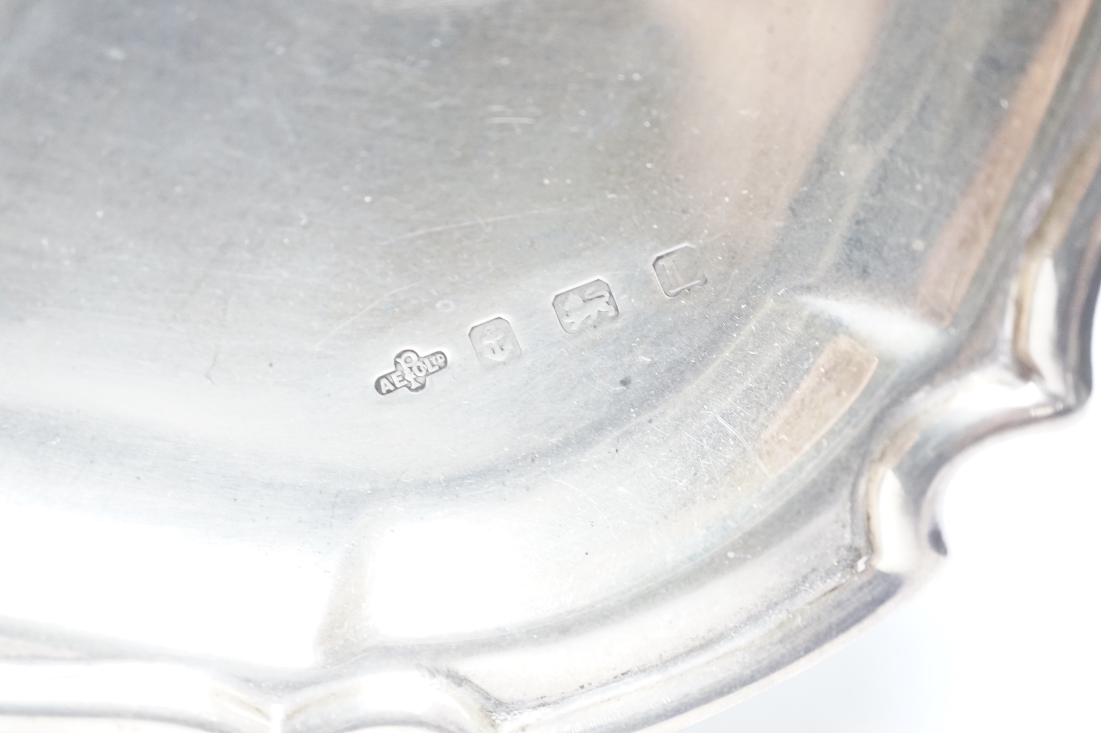 A George V silver shaped square presentation salver, with later engraved inscription, A.E. Poston & Co Ltd, Birmingham, 1935, 25.6cm, 23oz.
